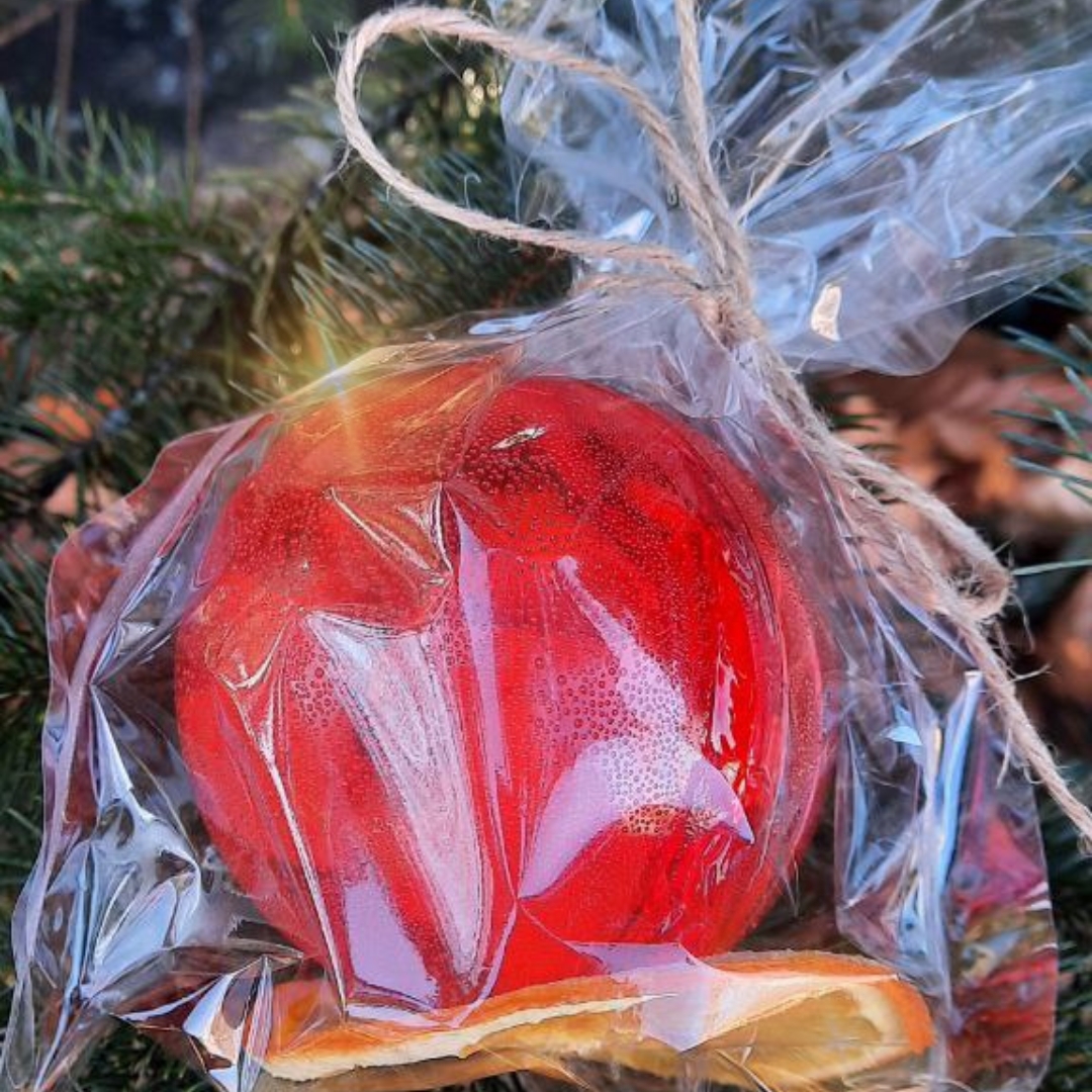 Beautifully handcrafted tea sphere with vibrant colors, wrapped elegantly for a luxurious presentation