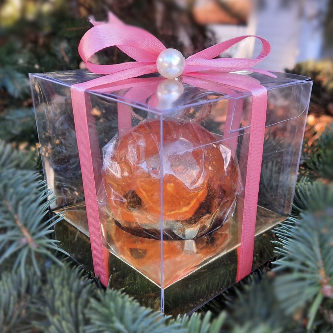 Gift box of Winter Berry Bliss tea spheres, elegantly wrapped with a pink ribbon, perfect for festive gifting.