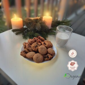 Homemade sugar-free cookies displayed on a festive table with warm candlelight and holiday decorations.